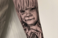 Little girl with rose tattoo by Zindy Ink